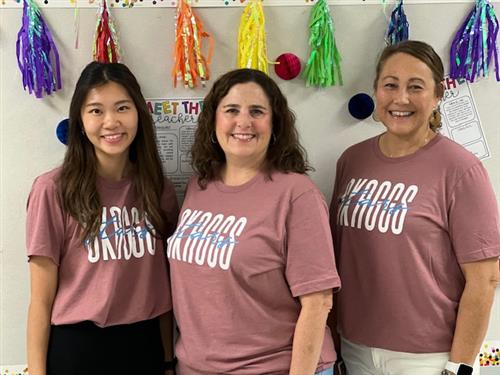Ms. Lim, Mrs. Resser, and Mrs. Ashley-Vasquez wearing their team shirts and smiling